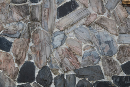 Stone wall and Old brick wall, multicolored stones Adorned on the walls background texture. Abstract