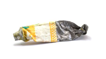 Close-up Old tube of artist oil paint with yellow colors on white backgroundの写真素材