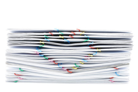 Pile overload white paperwork with colorful heart-shaped paperclip place on white background.