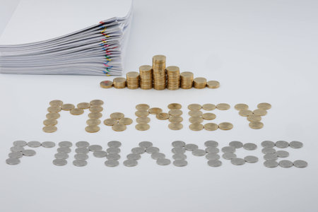 Pile overload document with colorful paperclip and step pile of gold coins with sort gold and silver coins as money and finance on white background.の写真素材