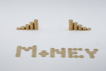 Step pile of gold coins with sort gold coins as money on white background.の写真素材
