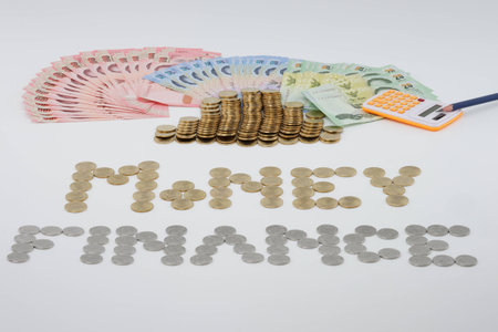Pile of gold coins and money with Sort gold and silver coins as money and finance with pencil and...