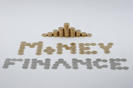 Step pile of gold coins with sort gold and silver coins as money and finance on white background.の写真素材