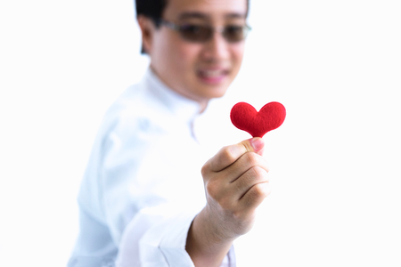 Blur smiling young man Chef closeup of hand with little heart on white background.の写真素材