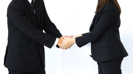 Handshake of business man and woman in strategic relationships on white background.の写真素材