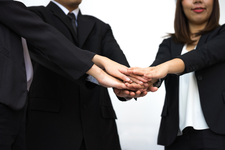 Business teamwork concept with hands stacking of businessman and businesswomen to success on white background.の写真素材