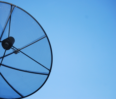Satellite dish in blue sky の写真素材