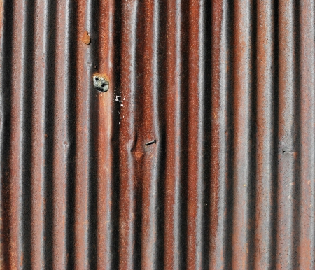 Old rusty damaged piece of metal roofingの写真素材