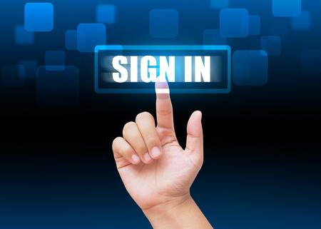 Hand pressing "SIGN IN" button with technology backgroundの写真素材