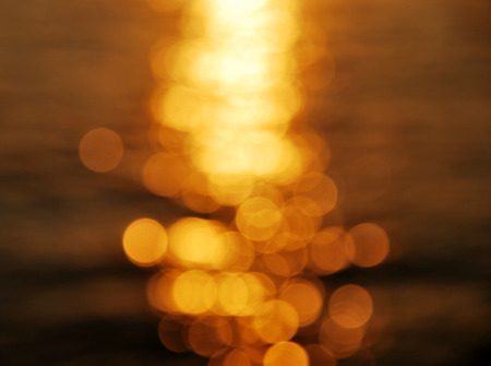 Gold bokeh on sunset backgroundの写真素材