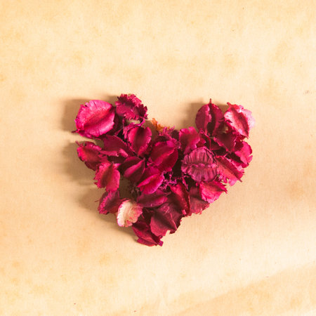 Dried flowers in shape of heart on wooden backgroundの写真素材