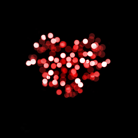 Heart shape Bokeh on dark backgroundの写真素材