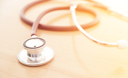 Stethoscope on wooden background for medical or science conceptの写真素材