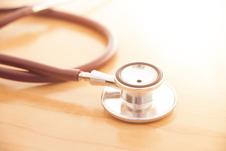 Stethoscope on wooden background for medical or science conceptの写真素材
