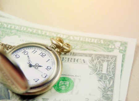 Money saving concept with vintage clock for the past.