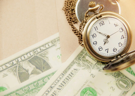 Money saving concept with vintage clock for the past.の写真素材
