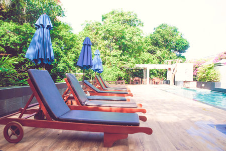 Beds and swimming pool with blue water background