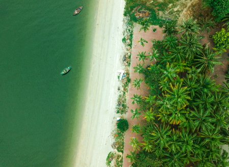 Aerial top view with fishing boat and sea beach backgroundの写真素材