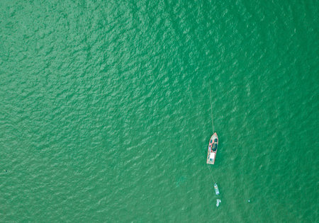 Aerial top view with fishing boat and sea beach backgroundの写真素材