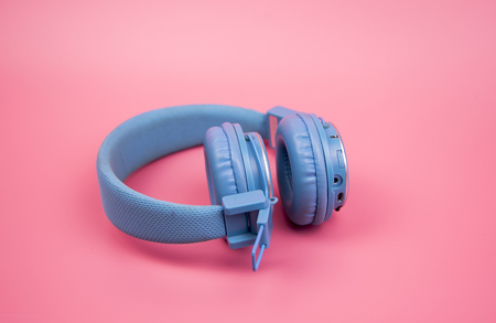 Blue headphone on light pink background,vintage or pastel conceptの写真素材