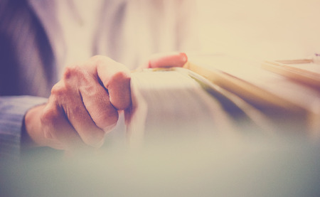 Teacher try to select text books in library with soft light vintage styleの写真素材