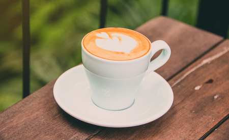 Hot coffee ready to drink on wood table backgroundの写真素材
