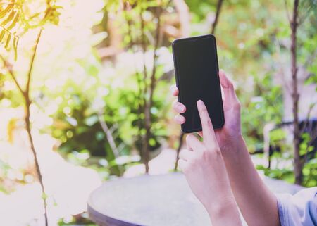 Woman hand pressing mobile phone to booking hotelの写真素材