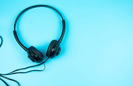 Headphones on blue pastel background