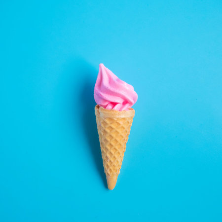 Colorful sweet ice cream cone isolated on blue pastel background ,holiday and relax conceptの写真素材