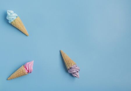 Colorful sweet ice cream cone isolated on blue pastel background ,holiday and relax conceptの写真素材