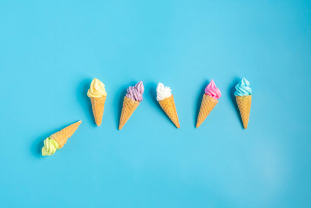 Colorful sweet ice cream cone isolated on blue pastel background ,holiday and relax conceptの写真素材