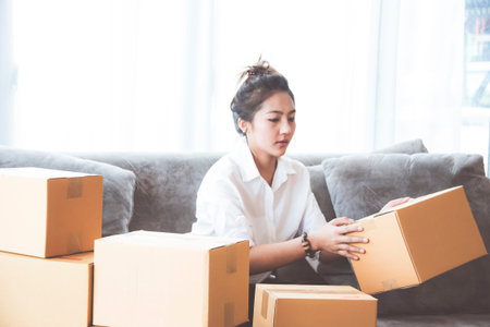 Woman packing and check address customers who order shopping online,work from home and delivery...