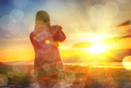 Abstract Blurred and soft photo of Women on hilltop with bokeh of sunrise on the natural backgroundの写真素材