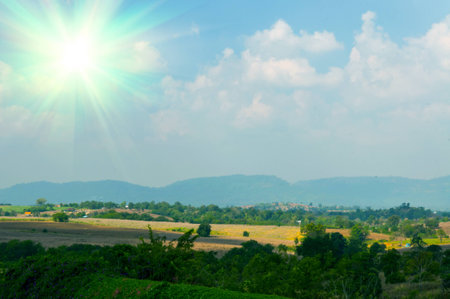 Abstract background of blue sky and white clouds with the sun shiningの写真素材