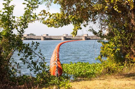 Orange Waste trap buoys in the river near dam.の写真素材