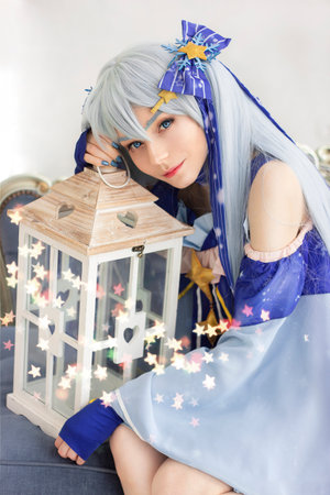 Cute young girl dressed as wizard with magic lanternの写真素材