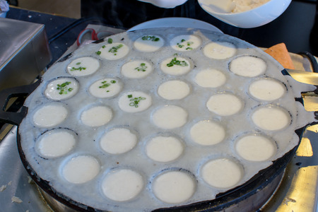 Traditional Thai Sweet in the market, made from coconut milk and flour. This food called "Kanom Krok".の写真素材