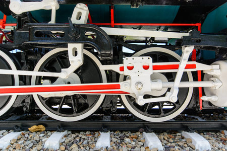 Wheels and connecting rod of old steam locomotive on railway