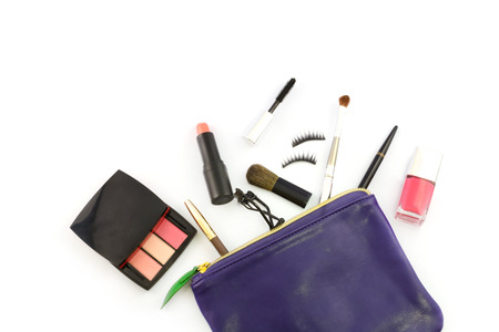 make up bag with cosmetics and brushes isolated on whiteの写真素材
