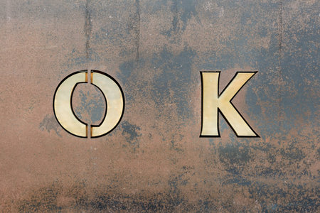 Grunge metal background with O and Kの写真素材