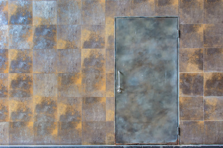 rusty wall background with metal doorの写真素材