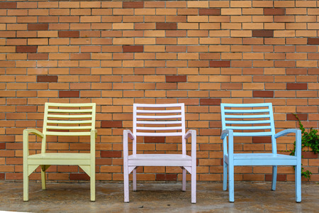 color wooden chair with brick wall backgroundの写真素材