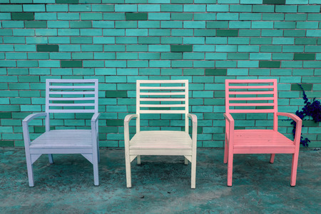 color wooden chair with brick wall backgroundの写真素材