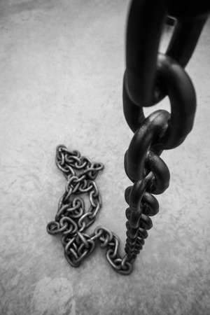 Rusty chain on floorの写真素材