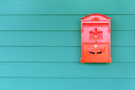 Red mailbox with green wood, vintage styleの写真素材