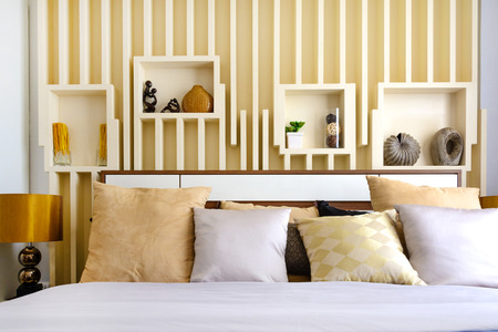 Modern bedroom with lamp and pillowsの写真素材