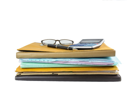 Stack of document with pen and calculator isolated on whiteの写真素材