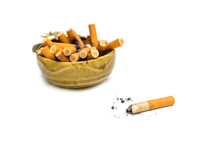 Full of cigarettes in ashtray isolated on whiteの写真素材