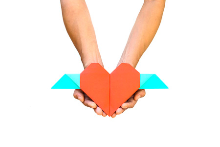 Hand with red heart shape paper isolated on white backgroundの写真素材