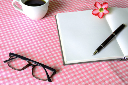Blank note book with cup of coffeeの写真素材